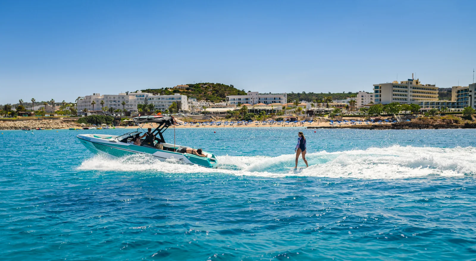 Wakeboarder catching air behind a Malibu boat off the Cyprus coast